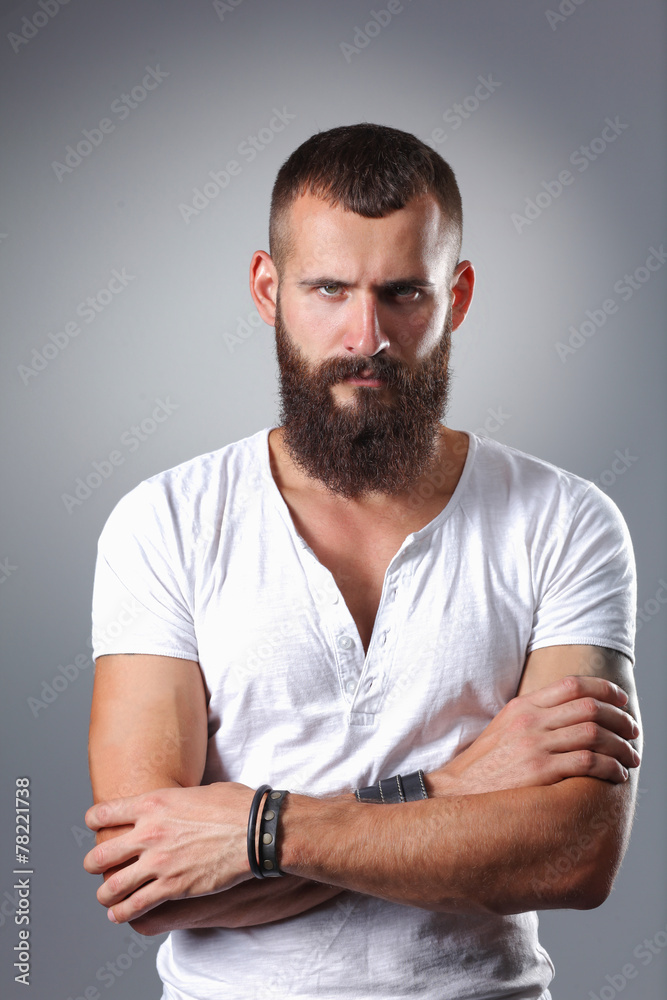 Portrait of handsome bearded man standing with crossed arms Portrait of handsome bearded man standing with crossed arms