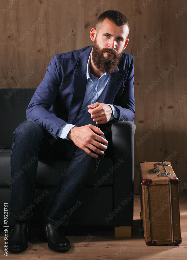 Businessman sitting the sofa in office lobby, isolated on dark Businessman sitting the sofa in office lobby, isolated on dark