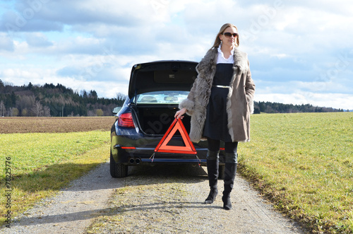 Broken car, girl and warning triangle © HappyAlex