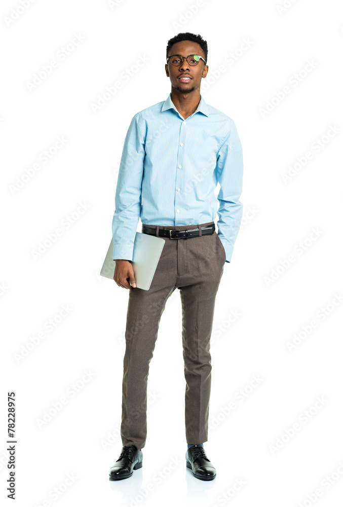 Fototapeta premium Happy african american college student standing with laptop on w