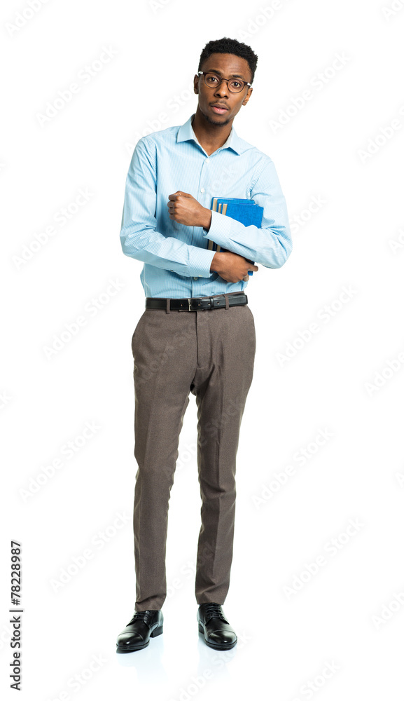 Happy african american college student standing with books in hi Happy african american college student standing with books in hi