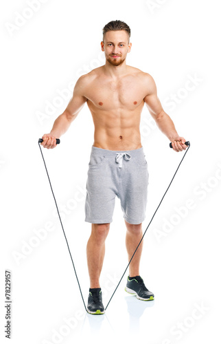 Athletic attractive man with a rope on the white