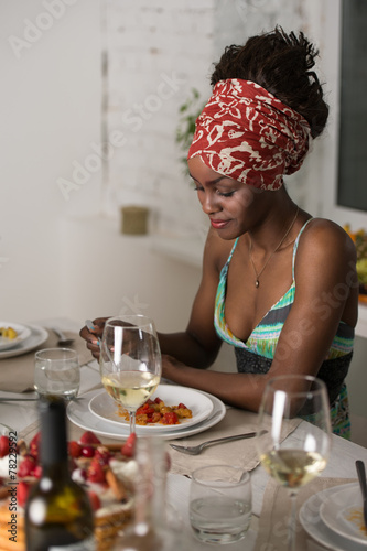 African woman eating at home