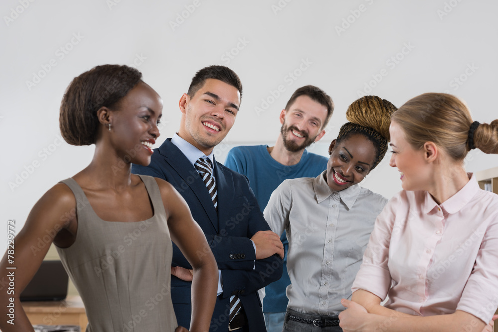 Happy business team standing together at office Happy business team standing together at office