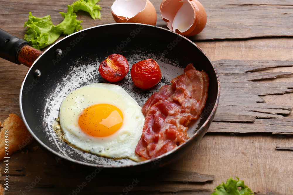 Bacon and eggs on rustic wooden planks background Bacon and eggs on rustic wooden planks background