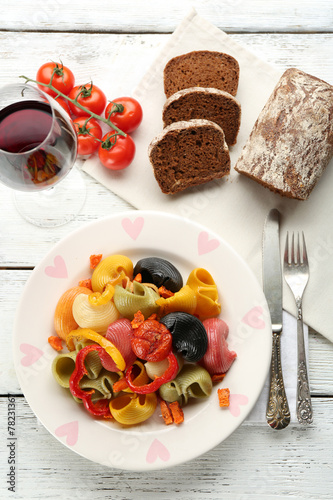 Tasty multicolor pasta with pepper, carrot and tomatoes