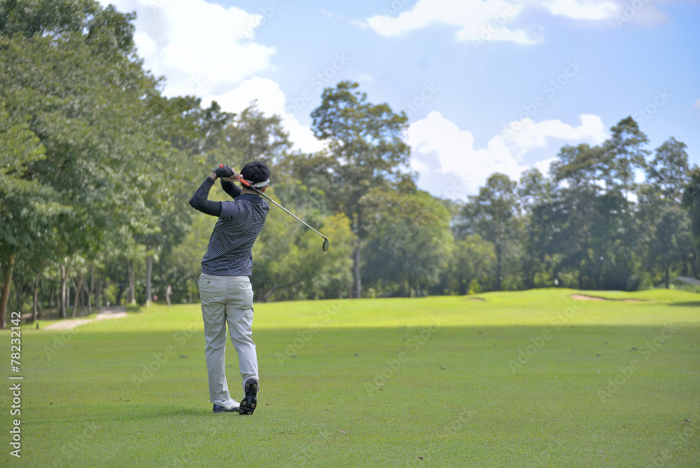Golf player pitching the golf ball, ball in the air. Golf player pitching the golf ball, ball in the air.