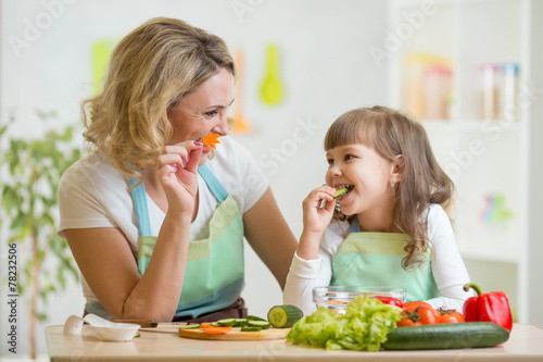 kid girl and mother eating healthy food vegetables