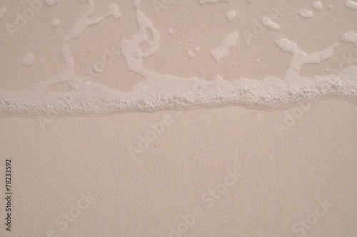 Water foam over sand.