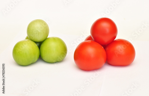 Pyramid of fresh green and red tomato on white background