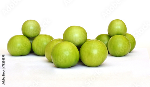Vászonkép Pyramid of fresh green tomato on white background