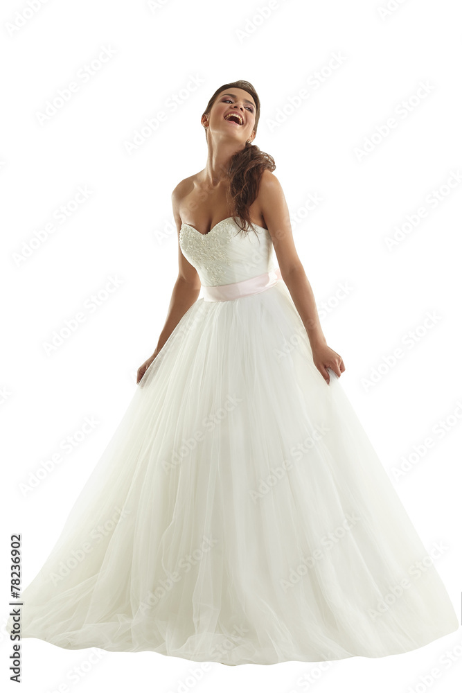 Cheerful bride posing in fashionable wedding dress