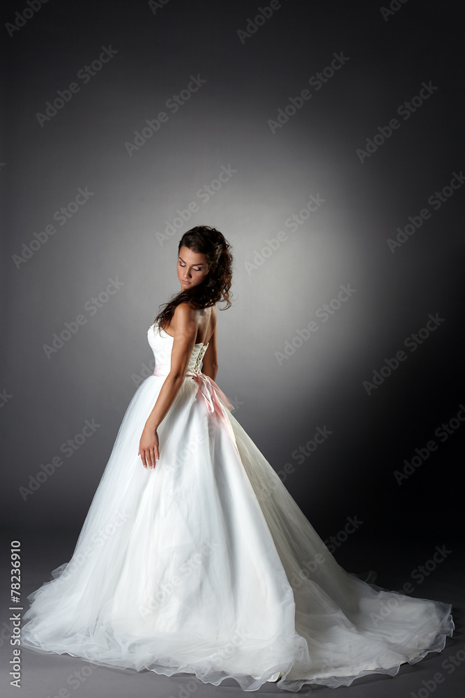 Modest bride posing in elegant dress with plume Modest bride posing in elegant dress with plume
