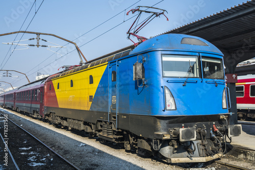 Red yellow and blue Romanian locomotive in Bucharest