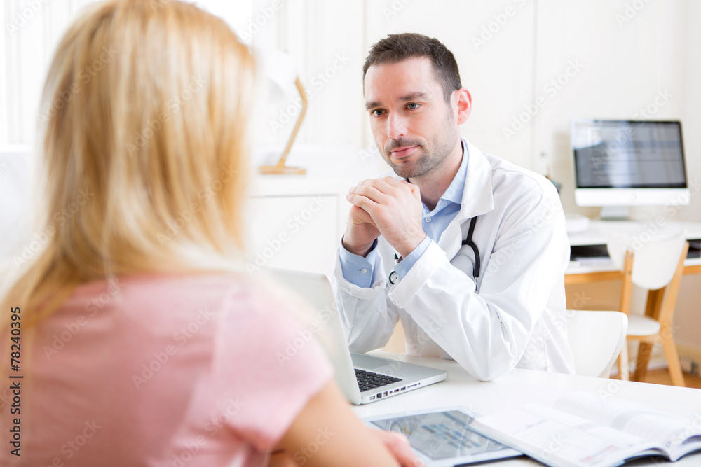 Young attractive doctor listening his patient