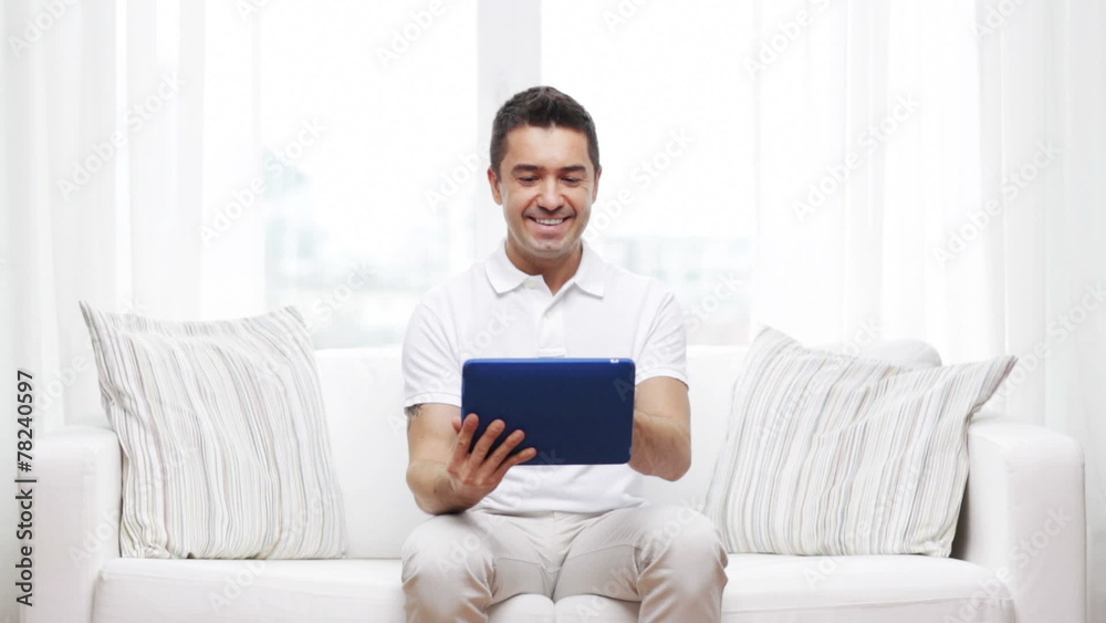smiling man working with tablet pc at home smiling man working with tablet pc at home