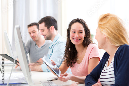 Young attractive people working together at the office