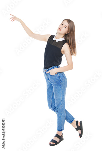 Young fashion girl in jeans posing isolated