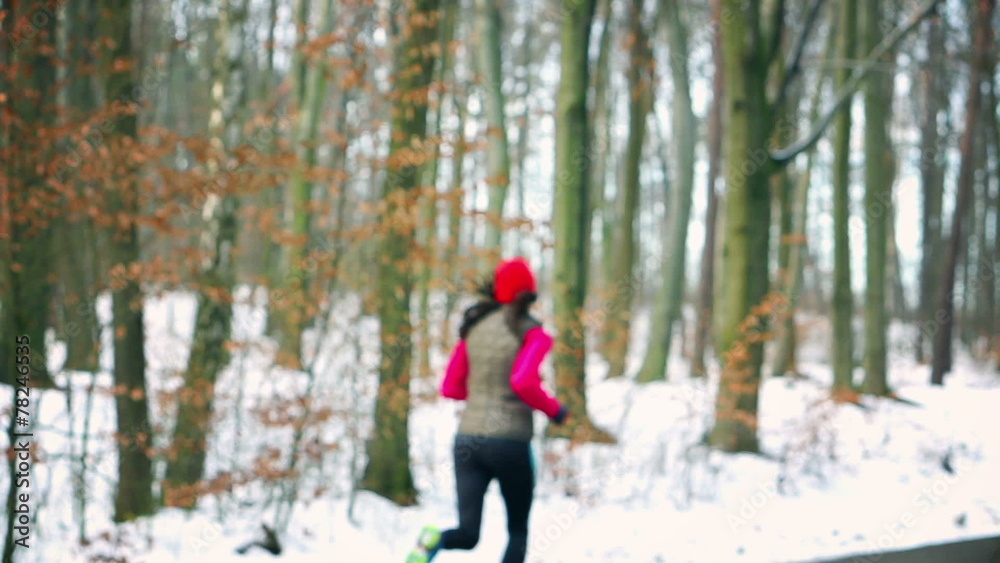 Jogger running in the forest at winter time, steady,slow motion Jogger running in the forest at winter time, steady,slow motion