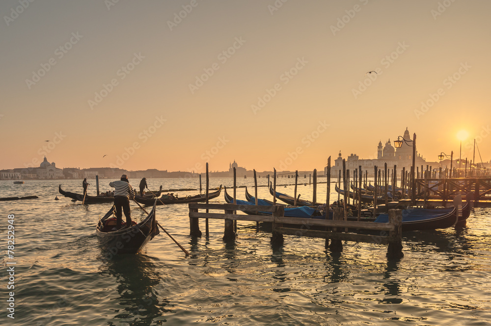 Venetian gondolas on the Grand Canal in a romantic light of suns