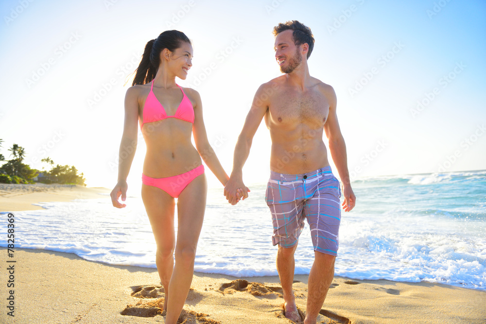 Couple romantic walking in beach sand holding hand Couple romantic walking in beach sand holding hand