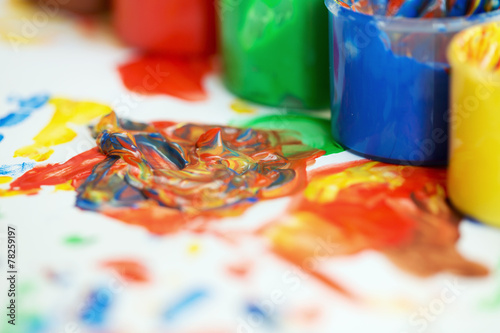 Jars of finger paint on a painting