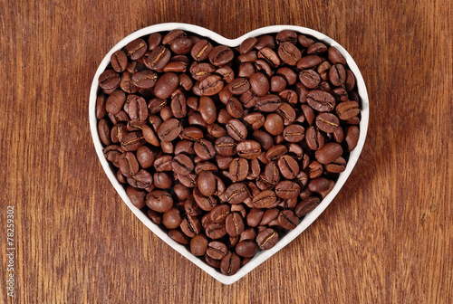 Coffee beans in plate in the form of heart