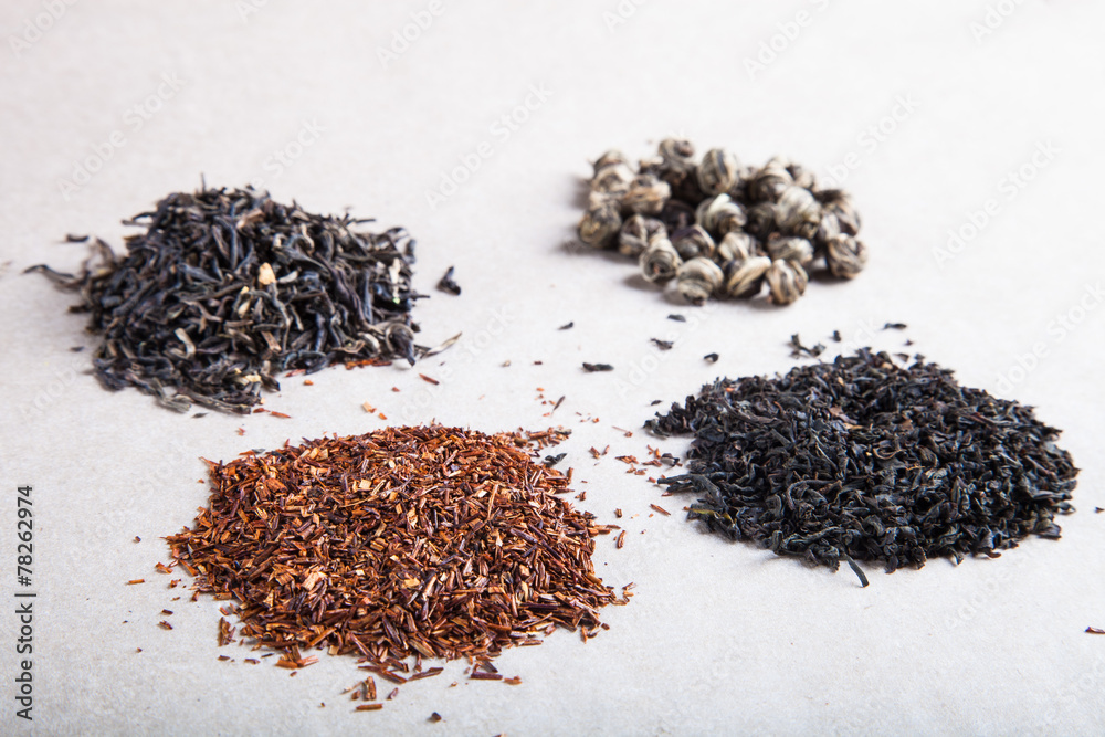 Four kinds of tea on a paper background Four kinds of tea on a paper background