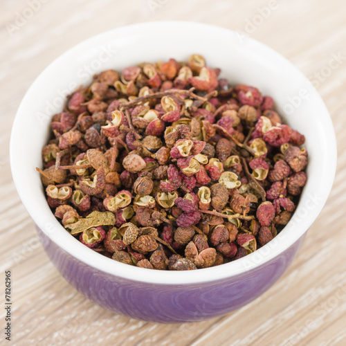 Szechuan Pepper - Szechuan peppercorns in a purple bowl.