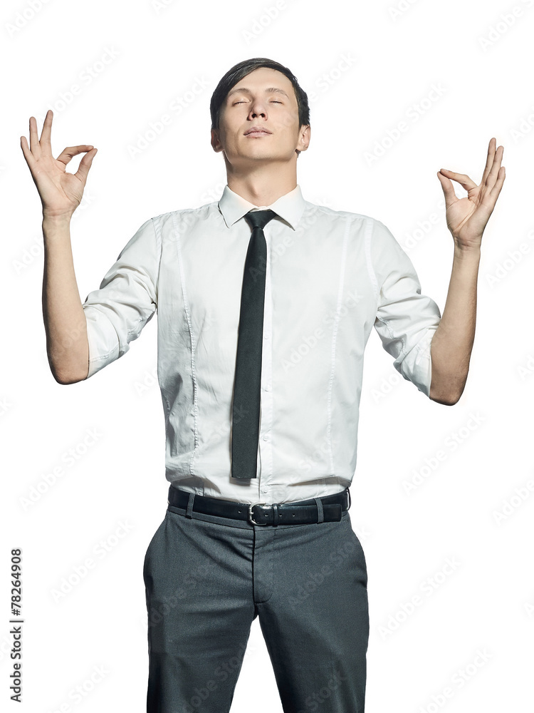 Young man in shirt in zen position isolated on white background Young man in shirt in zen position isolated on white background