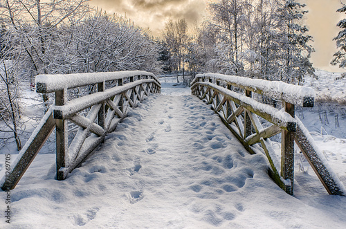 Wooden bridge, covered with snow. Stare Juchy, Poland.