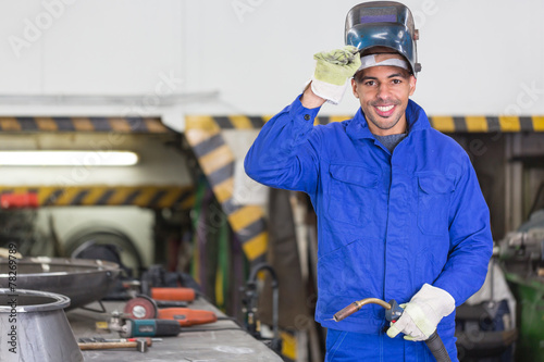 Professional welder posing with wellding machine photo