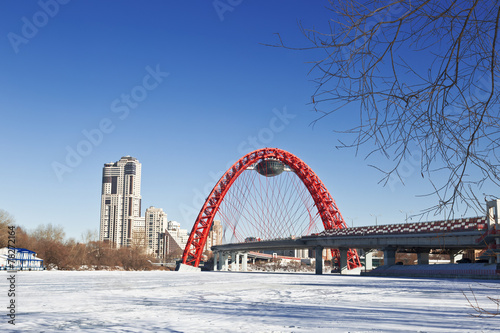 Red bridge over the frozen Moskva river, Moscow, Russia photo