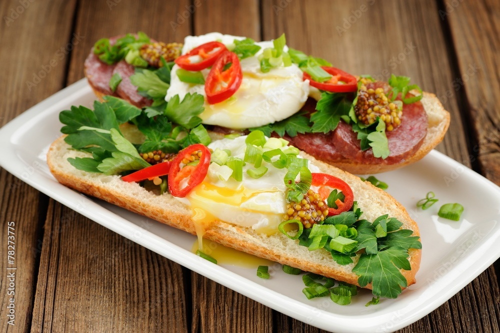 Poached egg sandwiches with chili, scallion and salami