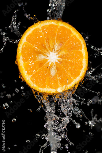 orange in water on a black background