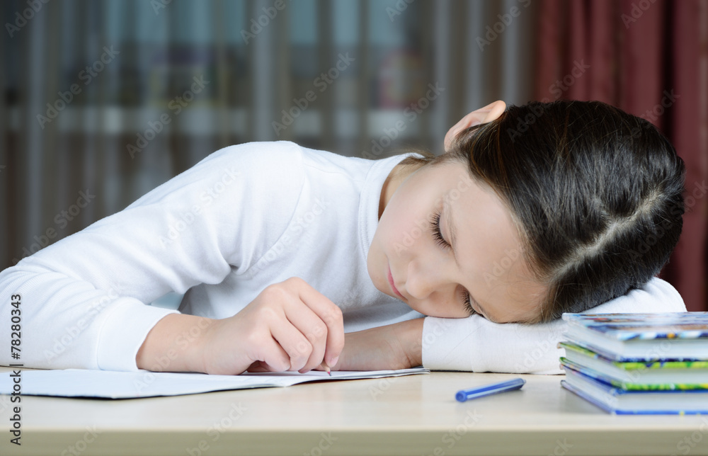 young schoolboy girl does his homework