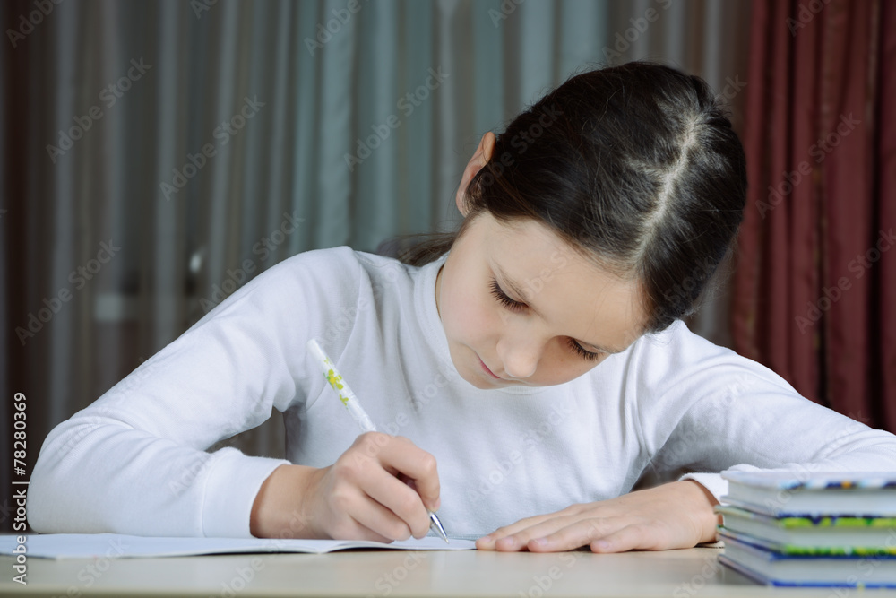 young schoolboy girl does his homework