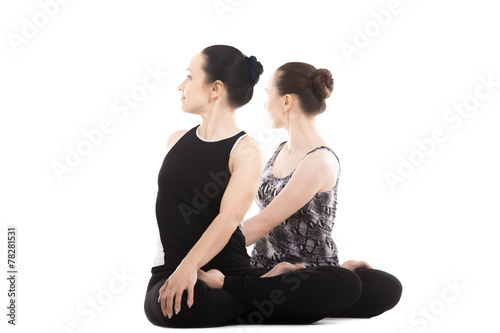 Two Yogi female partners sitting in yoga Lotus Pose