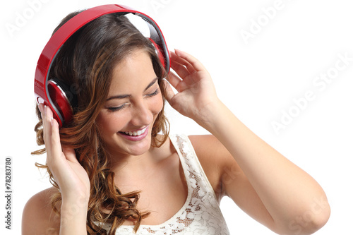 Happy woman enjoying listening to the music from headphones