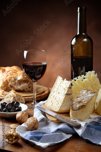 Red wine, cheese, walnuts, olives, and bread