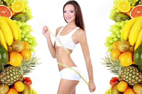 Beautiful young woman measu...