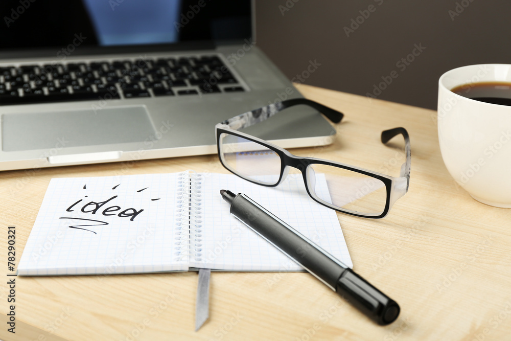 Cup of coffee with note Idea in notebook and glasses Cup of coffee with note Idea in notebook and glasses