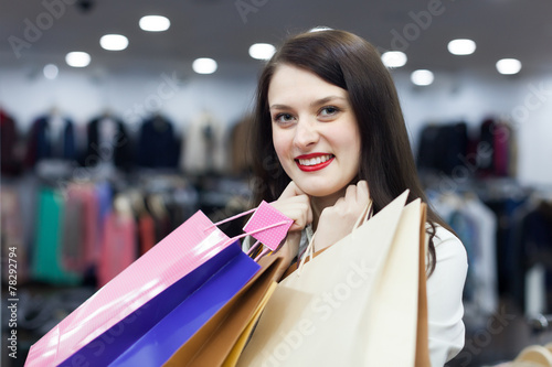Happy brunette girl with shopping bags