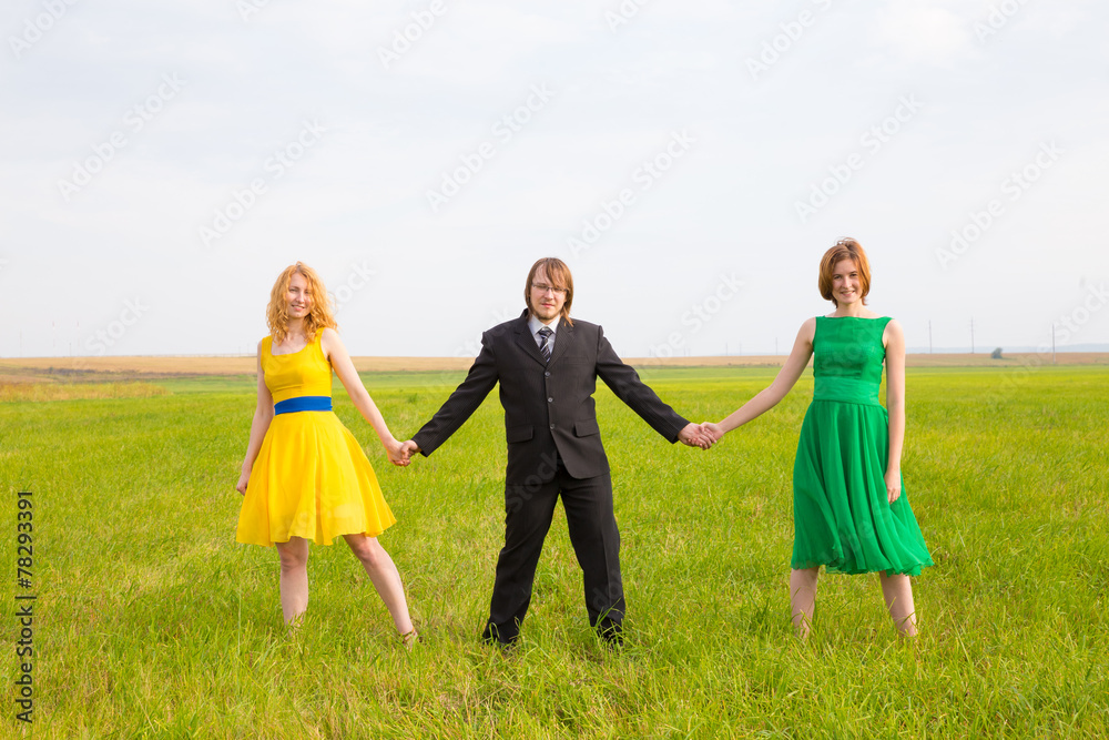 two girls share one man in the field two girls share one man in the field