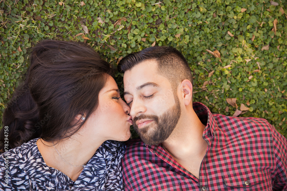 Fototapeta premium Kissing boyfriend in the cheek