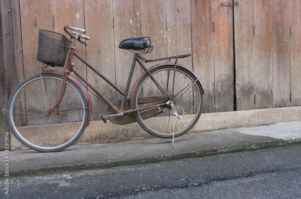 old bicycle on wood background