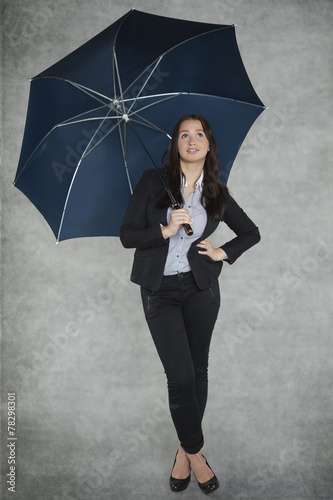 beautiful businesswoman under umbrella photo