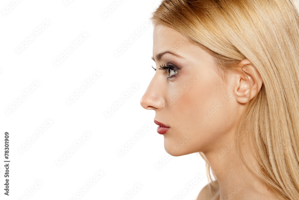 profile of serious young blonde on a white background profile of serious young blonde on a white background