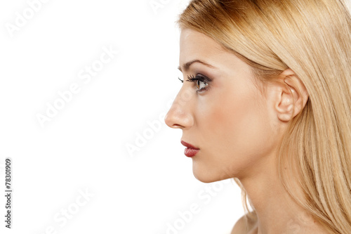 profile of serious young blonde on a white background