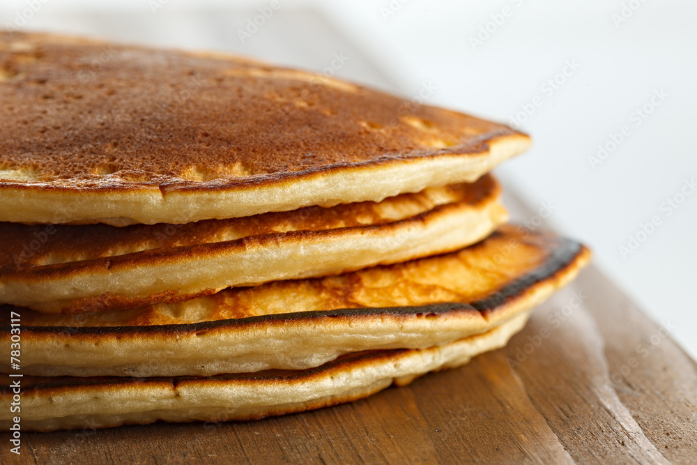 Fried pancakes on a wooden surface. Fried pancakes on a wooden surface.